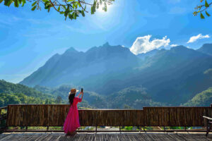 Woman tourist taking photo of Doi Luang Chiang Dao mountains, Chiang mai, Thailand.